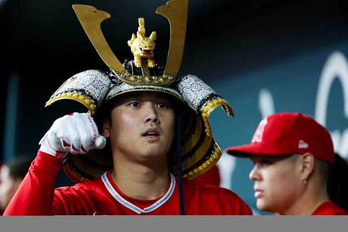 Aug 16, 2023; Arlington, Texas, USA; Los Angeles Angels designated hitter Shohei Ohtani (17) celebrates with teammates while wearing a samurai helmet after hitting a home run during the first inning against the Texas Rangers at Globe Life Field.